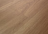 Close-up angled view of Mannington ADURA Flex Noble Oak Acorn luxury vinyl plank flooring highlighting the natural oak grain and warm brown tone